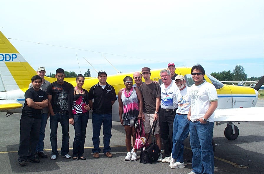 Alexis Jeffery receives congratulations from pilots and fellow student pilots after the completion of her First Solo Flight on June 23, 2008.  Langley Fliying School.